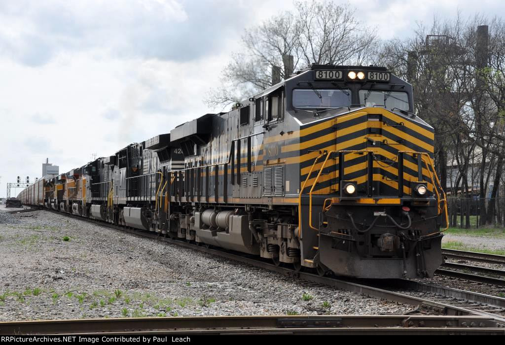 Westbound vehicle train approaches the diamonds behind the NKP heritage unit